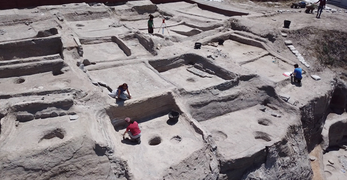 Archaeological site with people excavating