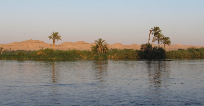 Egyptian landscape with water, mountains and trees