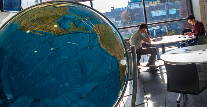 Globe and students studying