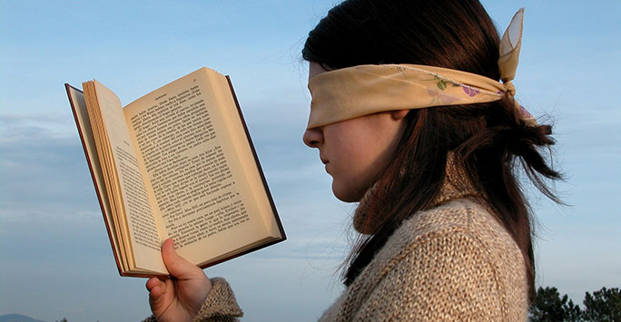 Blindfolded woman and book