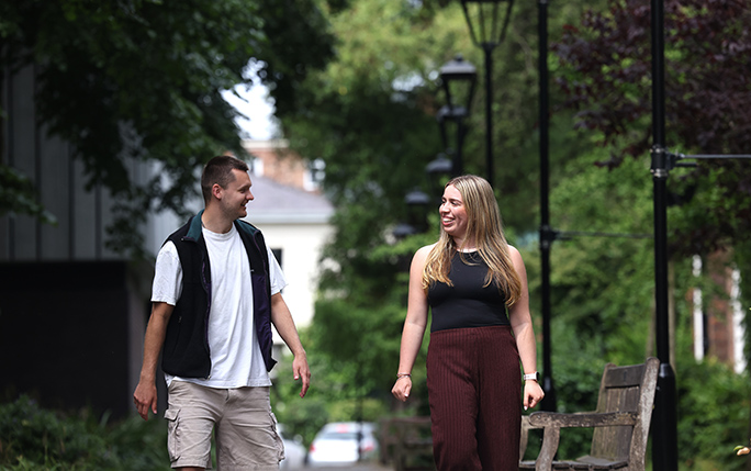 Two Economics students walking across campus