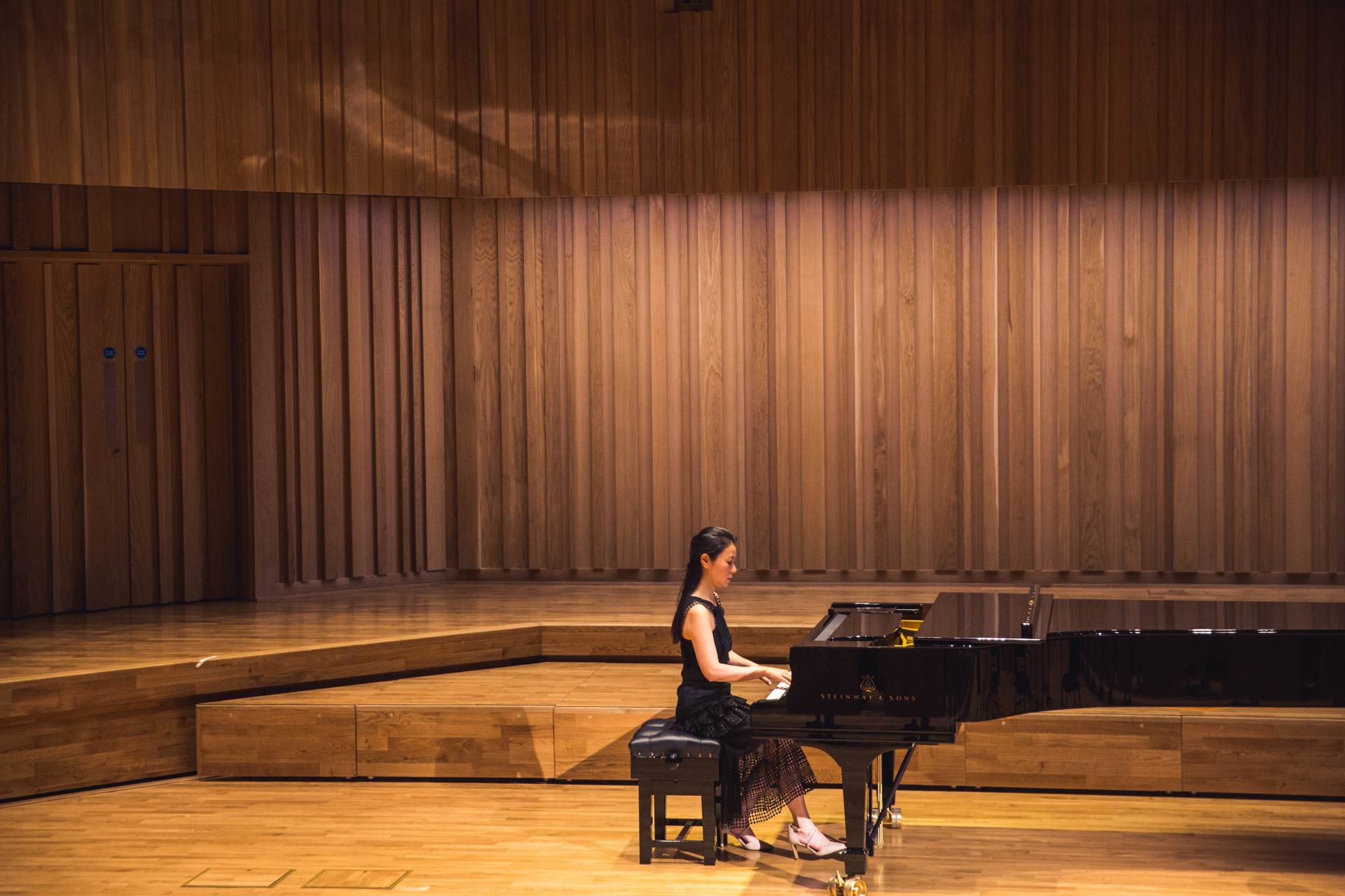 Pianist on stage in the Tung Auditorium