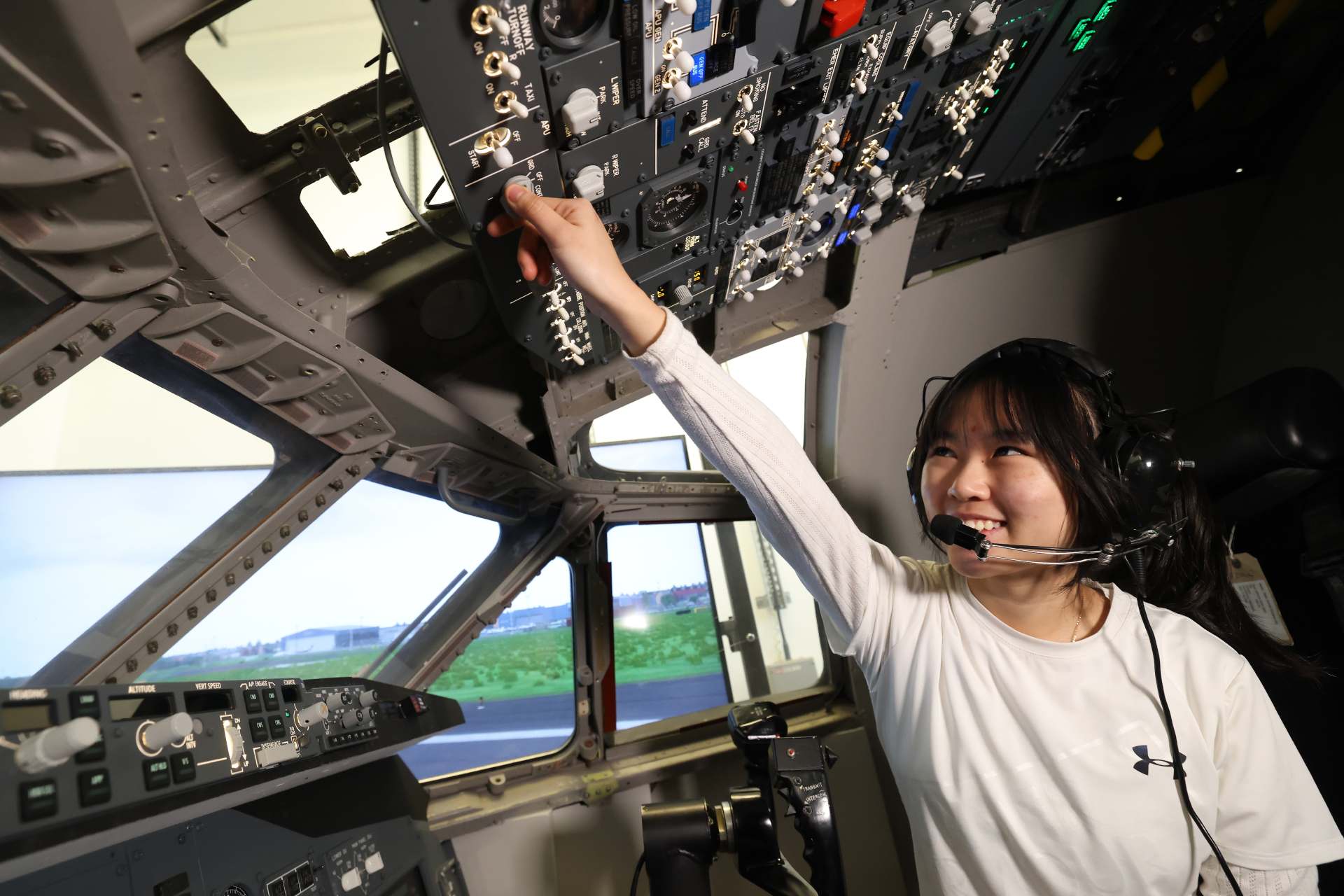 An aerospace engineering student working in an aircraft.