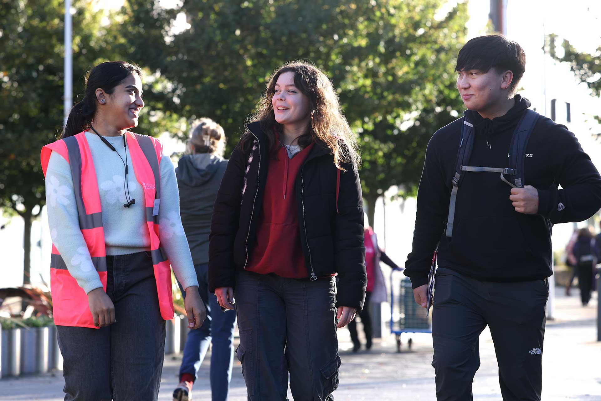 Two prospective students on a campus tour with a student guide during an open day.
