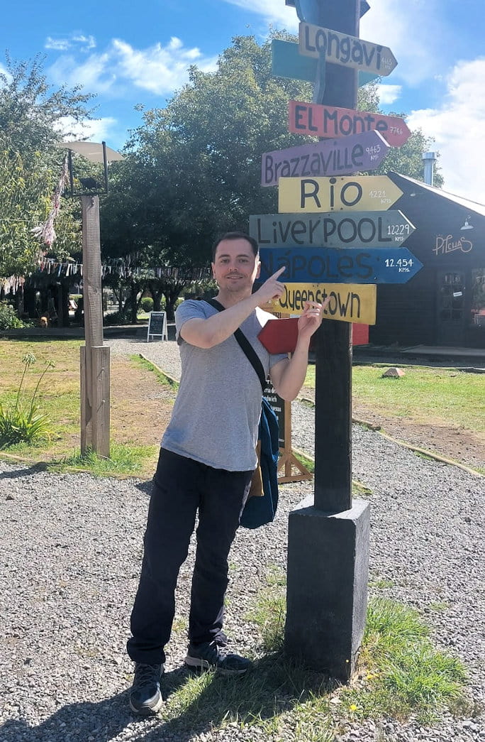 Daniel Leybourne pointing to Liverpool on a signpost in Chile