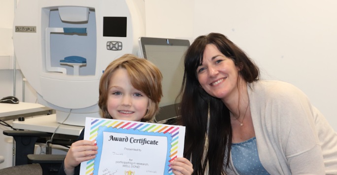 Child with a certificate having participated in research