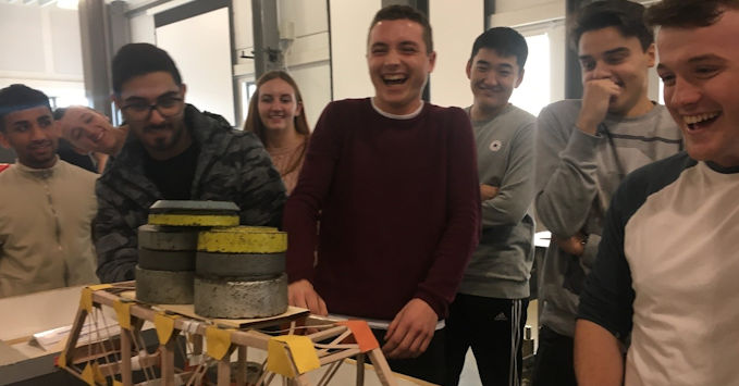 First year students building and then nervously testing to destruction their cardboard bridges as part of the Civil and Architectural Engineering Project